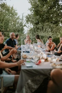 An intimate outdoor dinner at Fairy Oak, a rustic venue in Vrdnik, Serbia, surrounded by greenery and candlelight.